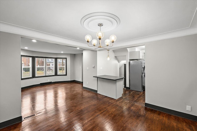 unfurnished dining area featuring dark hardwood / wood-style flooring and a chandelier