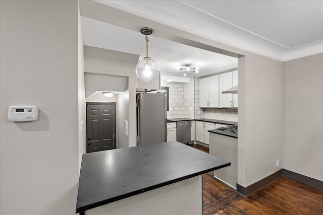 kitchen featuring decorative light fixtures, white cabinetry, backsplash, stainless steel appliances, and dark wood-type flooring