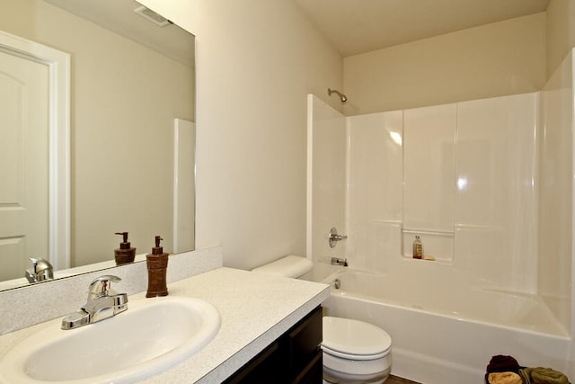 full bathroom featuring vanity, bathtub / shower combination, and toilet