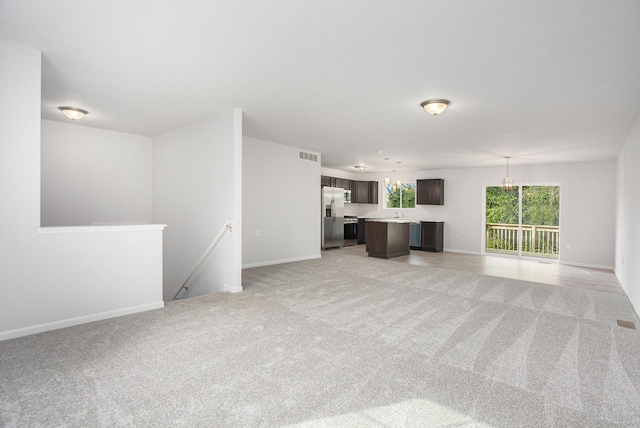 unfurnished living room with light carpet