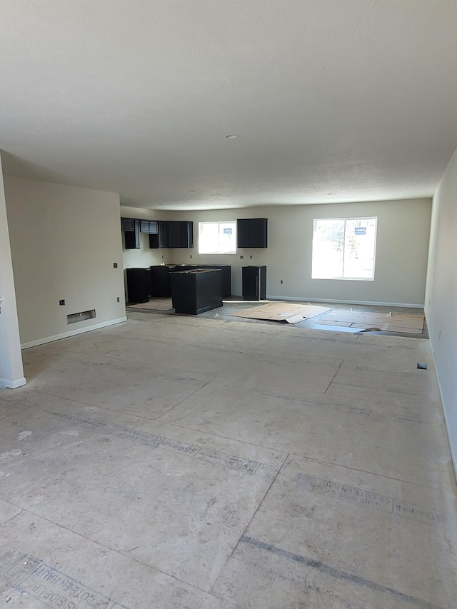 unfurnished living room with a wealth of natural light