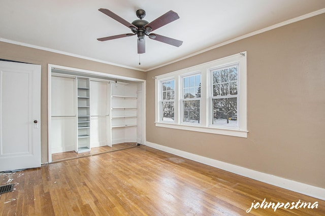 unfurnished bedroom with ornamental molding, hardwood / wood-style floors, and ceiling fan