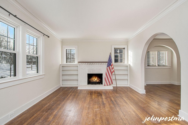 unfurnished living room featuring ornamental molding, dark hardwood / wood-style floors, and a fireplace