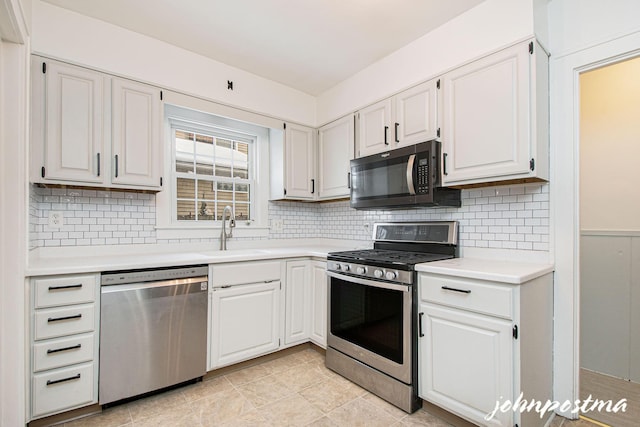 kitchen featuring white cabinetry, sink, backsplash, and appliances with stainless steel finishes