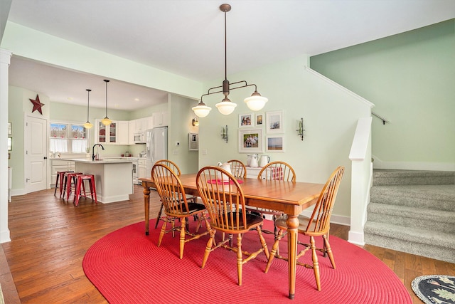 dining room with dark hardwood / wood-style floors and sink