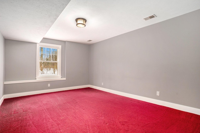 spare room with carpet floors and a textured ceiling