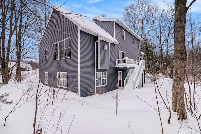 view of snowy exterior with a deck