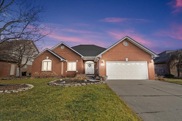 view of front of home featuring a garage and a lawn