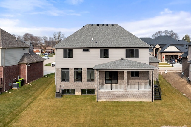 back of property with a patio, a lawn, and central air condition unit