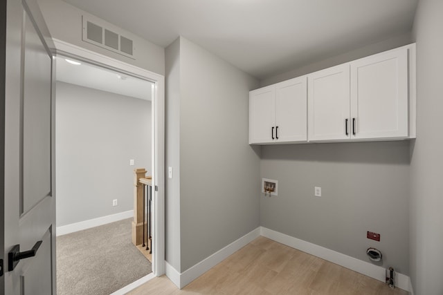 laundry area featuring cabinets, hookup for an electric dryer, washer hookup, and light hardwood / wood-style floors