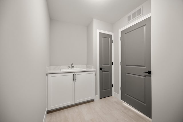 bathroom featuring hardwood / wood-style flooring and vanity