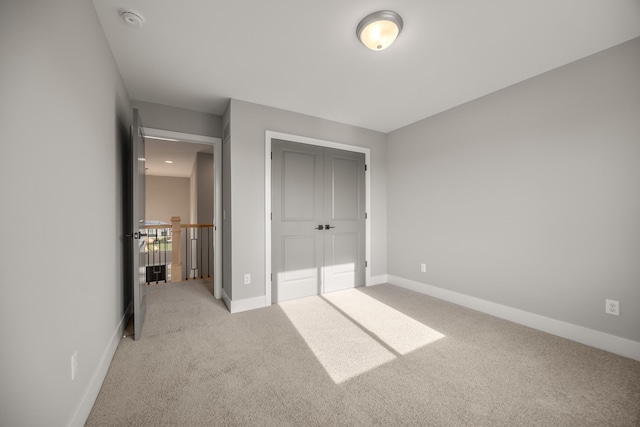 unfurnished bedroom featuring light colored carpet