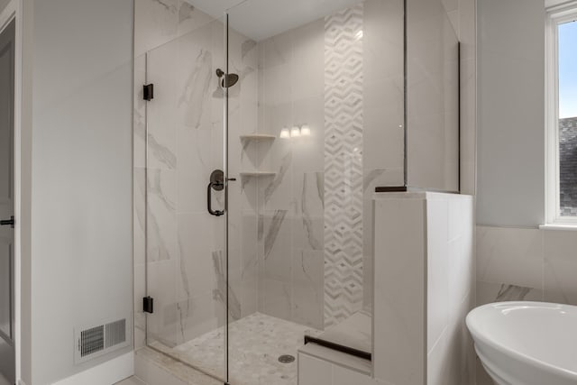 bathroom featuring tile walls and separate shower and tub