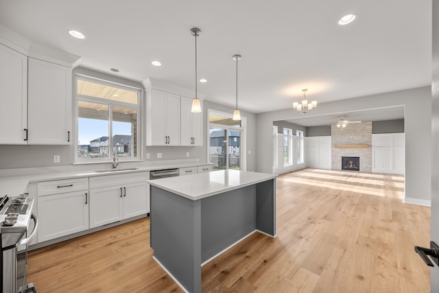 kitchen featuring white cabinetry, a center island, and appliances with stainless steel finishes