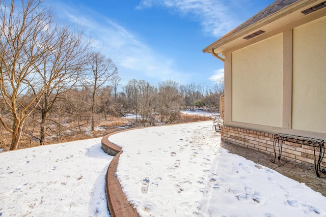 view of yard layered in snow