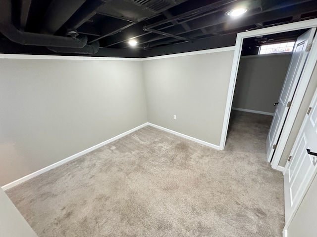 basement featuring light colored carpet