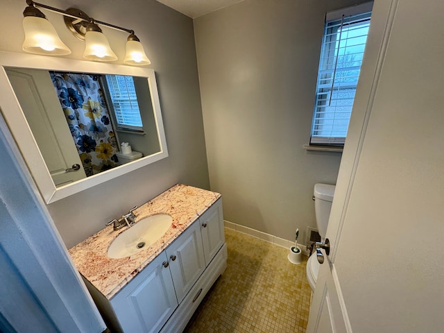 bathroom featuring vanity and toilet