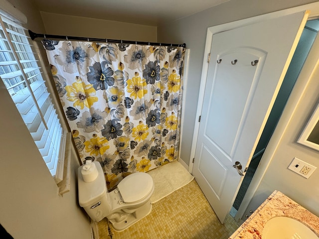 bathroom featuring vanity, toilet, tile patterned flooring, and a shower with shower curtain