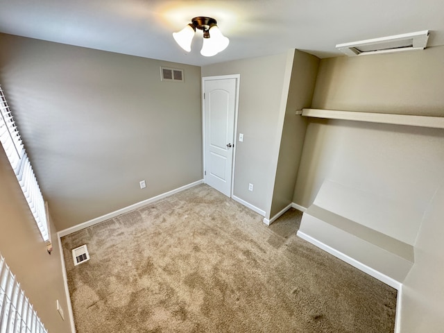 unfurnished bedroom with light colored carpet