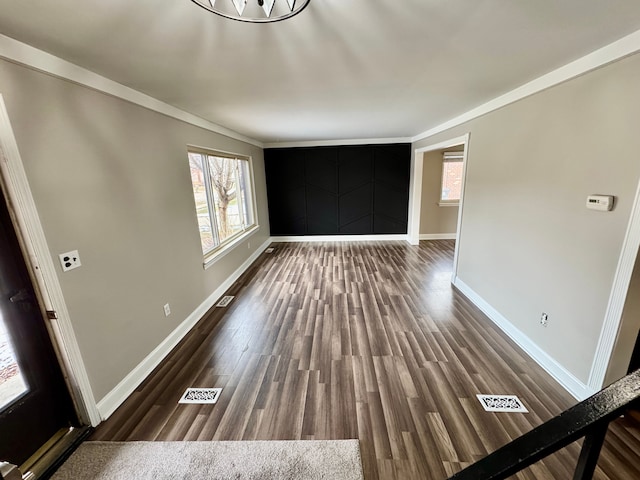 interior space with crown molding, dark hardwood / wood-style floors, and a wealth of natural light