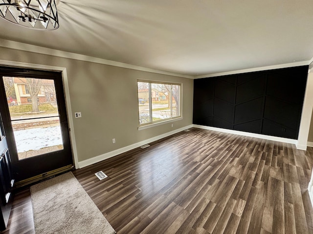 entryway with dark hardwood / wood-style floors and a chandelier