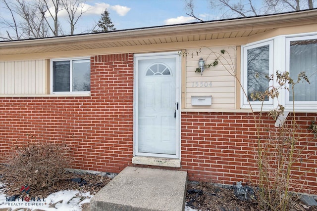 snow covered property entrance with french doors