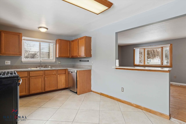 kitchen featuring light tile patterned flooring, sink, dishwasher, and gas stove