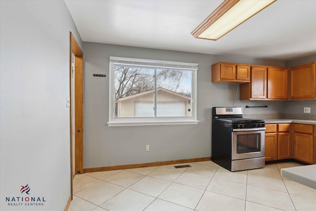 kitchen with light tile patterned floors and stainless steel range with gas cooktop