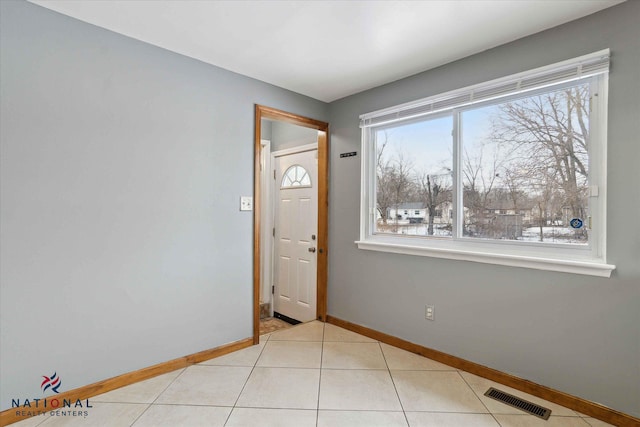 entryway with light tile patterned floors