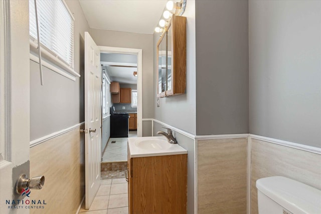 bathroom with tile patterned flooring, vanity, and toilet