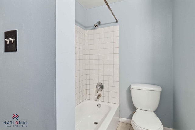 bathroom featuring tiled shower / bath and toilet