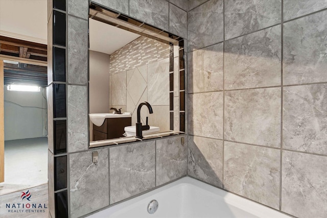 bathroom featuring a washtub and sink