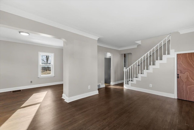 unfurnished living room featuring crown molding and dark wood-type flooring