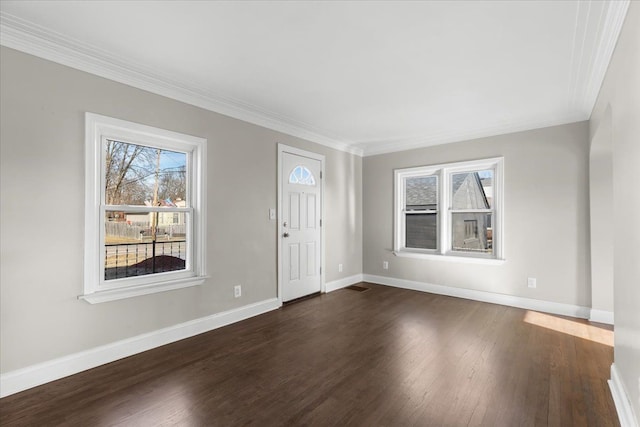 foyer with ornamental molding and dark hardwood / wood-style flooring