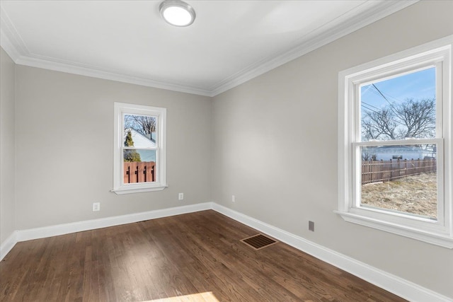 spare room featuring dark wood-type flooring and ornamental molding