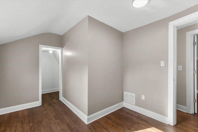 additional living space featuring lofted ceiling and dark wood-type flooring