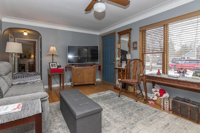 living room with crown molding, hardwood / wood-style floors, and ceiling fan