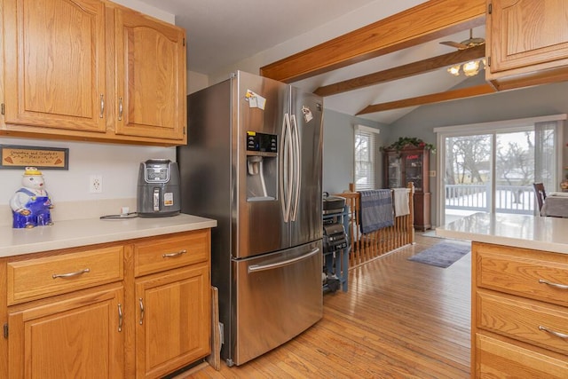 kitchen with stainless steel fridge with ice dispenser, vaulted ceiling with beams, ceiling fan, and light wood-type flooring