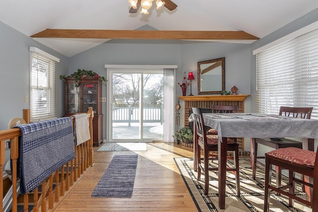 dining area featuring light hardwood / wood-style flooring, vaulted ceiling, and ceiling fan