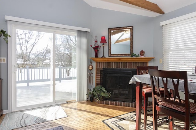 interior space with a fireplace, hardwood / wood-style flooring, and vaulted ceiling