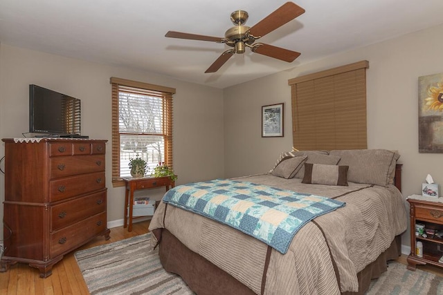 bedroom with ceiling fan and hardwood / wood-style floors