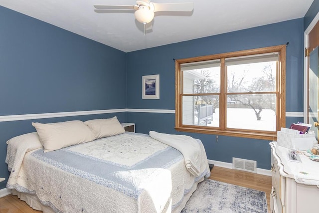 bedroom with ceiling fan and light hardwood / wood-style flooring