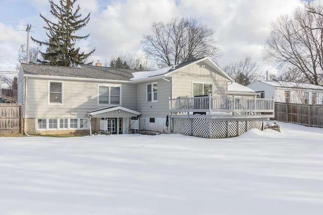 snow covered property featuring a wooden deck