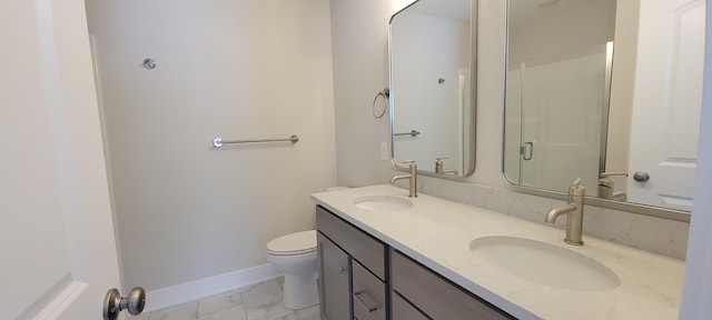 bathroom with vanity, toilet, and a shower with door