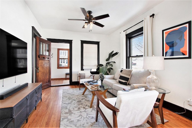 living room with wood-type flooring and ceiling fan