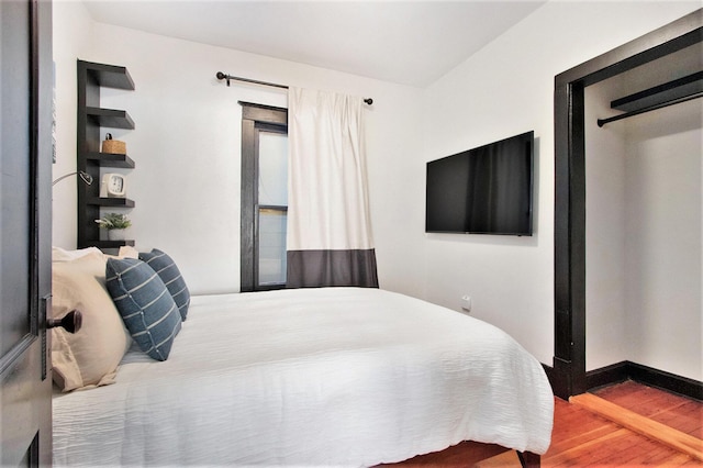 bedroom with hardwood / wood-style floors