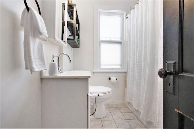 full bathroom featuring shower / bath combo with shower curtain, tile patterned floors, toilet, and vanity