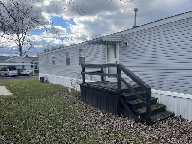 exterior space featuring cooling unit and a yard