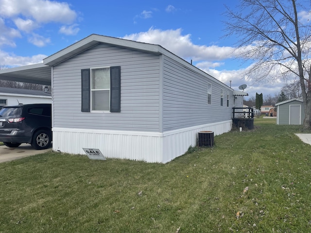 view of home's exterior with a carport, central AC unit, and a lawn