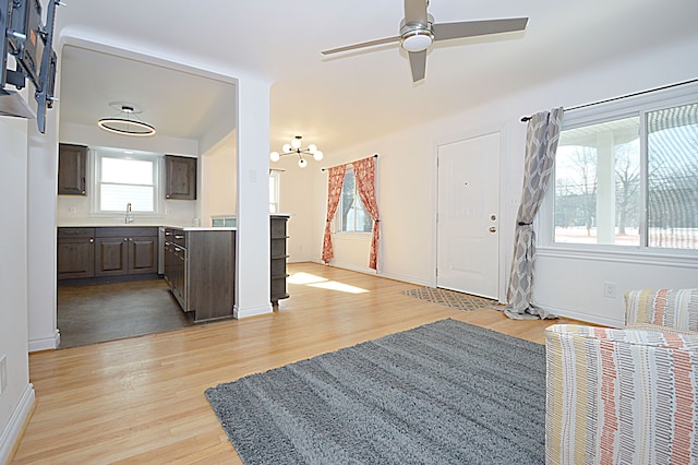 foyer with ceiling fan, sink, and light hardwood / wood-style floors